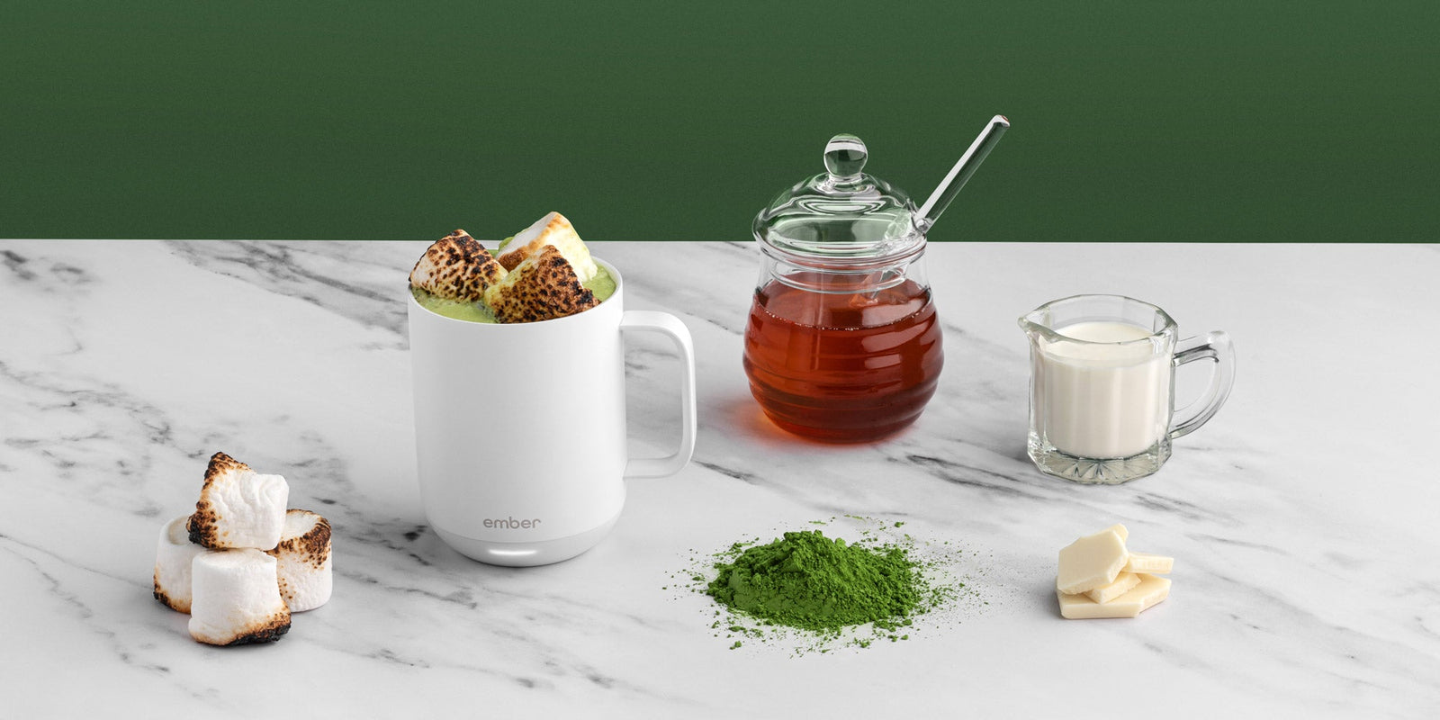 Matcha Hot Chocolate in a white Ember Mug2 and surrounded by toasted marshmallows, honey, and cream.